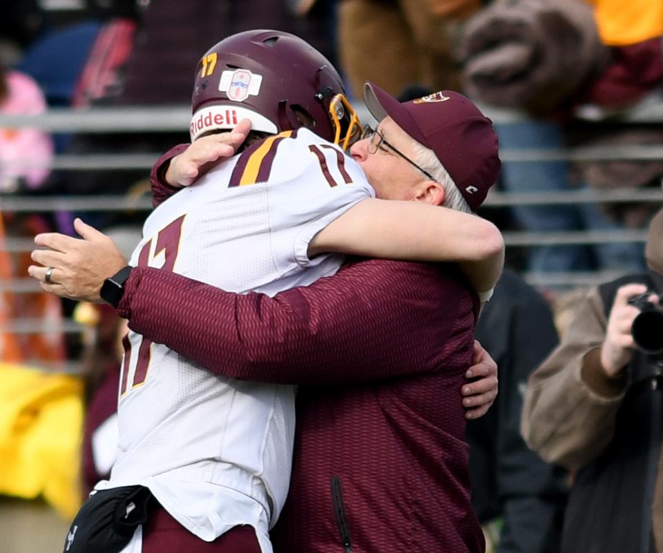 South Range's Billy Skripac celebrates with head coach Dan Yeagley their OHSAA Division V State Championship football win against Ironton in the OHSAA Division V State Championship football game at Tom Benson Hall of Fame Stadium.  Friday, December 02, 2022.