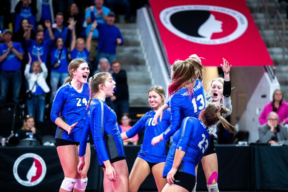 Holy Trinity's Teagan Snaadt, right, celebrates a point with Kate Bendlage (13) and teammates during a Class 1A state volleyball quarterfinal match against Gladbrook-Reinbeck, Tuesday, Nov. 1, 2022, at Xtream Arena in Coralville, Iowa.