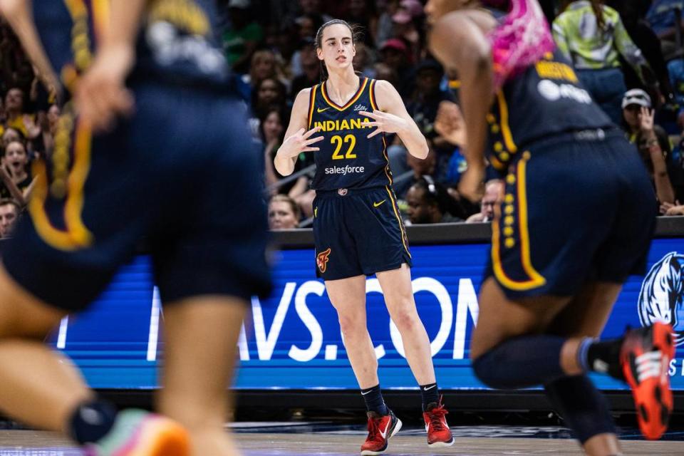 Indiana Fever guard Caitlin Clark (22) celebrates after hitting a three-point shot in the fourth quarter of a WNBA preseason game between the Dallas Wings and Indiana Fever at College Park Center in Arlington on Friday, May 3, 2024.
