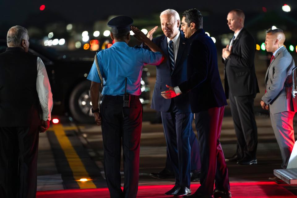 President Joe Biden greets Air Commodore AS Parandekar, Commanding Air Officer, as he arrives at Indira Gandhi International Airport to attend the G20 summit, Friday, Sept. 8, 2023, in New Delhi.