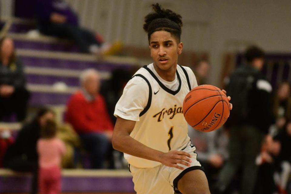 Topeka High junior Isaiah Lyons (1) dribbles the ball down the court during the first half of Thursday's game for the Topeka Invitational Tournament at Topeka West.