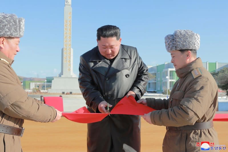 KCNA picture of North Korean leader Kim Jong Un cutting a ribbon during a completion ceremony for a vegetable greenhouse farm and tree nursery in Jungphyong, North Korea