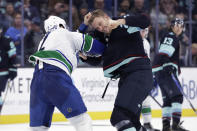 Seattle Kraken defenseman Jamie Oleksiak, right, fights with Vancouver Canucks defenseman Luke Schenn (2) during the second period of an NHL hockey game Wednesday, Jan. 25, 2023, in Seattle. (AP Photo/John Froschauer)