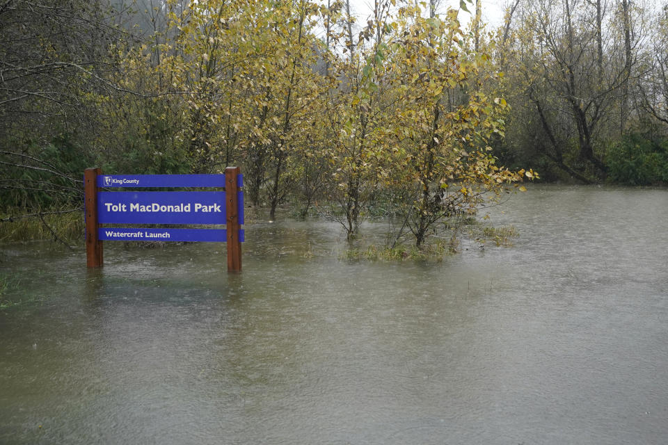 An entrance to Tolt MacDonald Park is shown under water, Friday, Nov. 12, 2021, as rain falls near Carnation, Wash. Forecasters said the storms are being caused by an atmospheric river, known as the Pineapple Express and rain was expected to remain heavy in Oregon and Washington through Friday night. (AP Photo/Ted S. Warren)