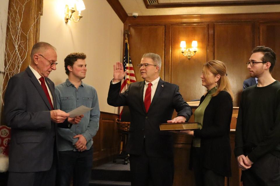 As one of his last acts as Old Tappan's mayor, John Kramer swears in new Mayor Thomas Gallagher Jan. 2 as son Brady, wife Sue and son Caden look on.