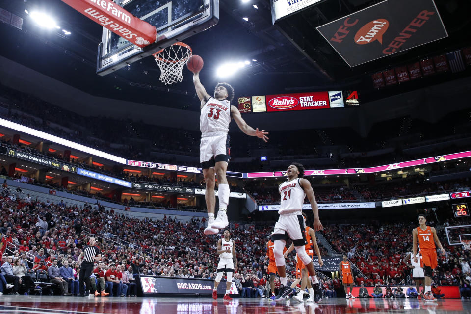 Louisville forward Jordan Nwora (33) dunks the ball during the second half of an NCAA college basketball game against Syracuse Wednesday, Feb. 19, 2020, in Louisville, Ky. Louisville won 90-66. (AP Photo/Wade Payne)