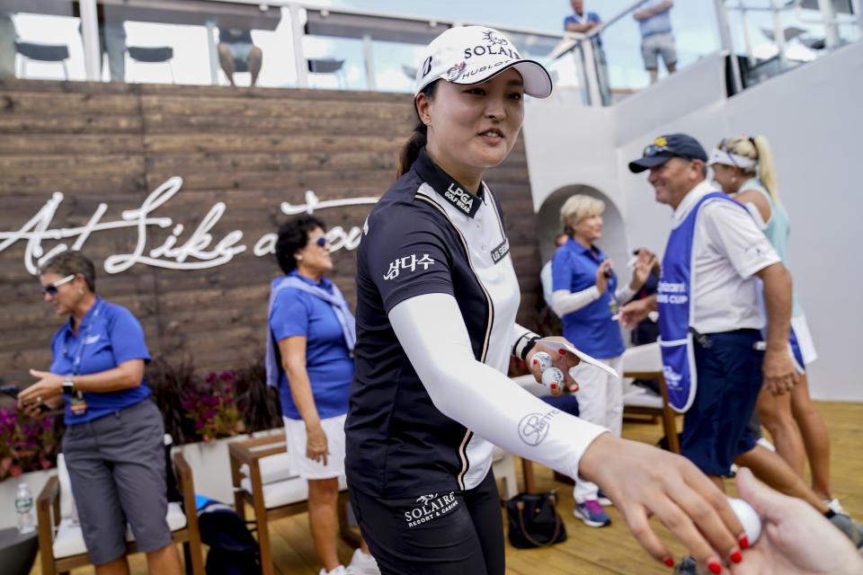 Jin Young Ko, of South Korea, hands autographed balls to volunteers after finishing the first round of the Cognizant Founders Cup LPGA golf tournament, Thursday, Oct. 7, 2021, in West Caldwell, N.J. (AP Photo/John Minchillo)