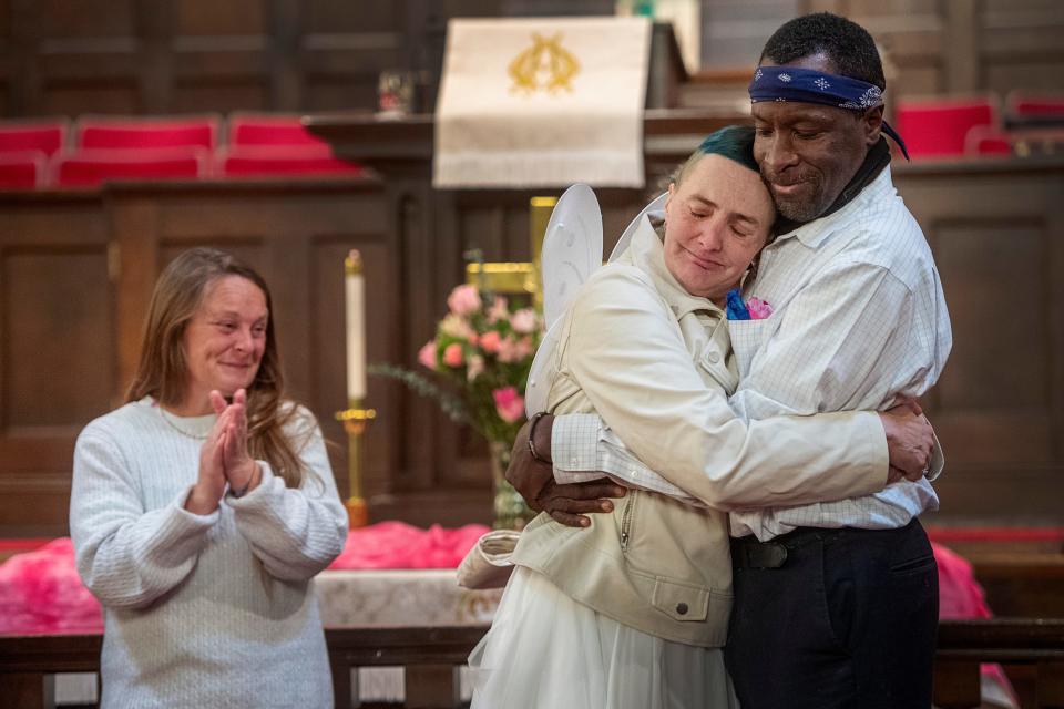 Christie and Jeffery Glenn hug after getting married at Trinity United Methodist Church in Asheville, January 21, 2024.