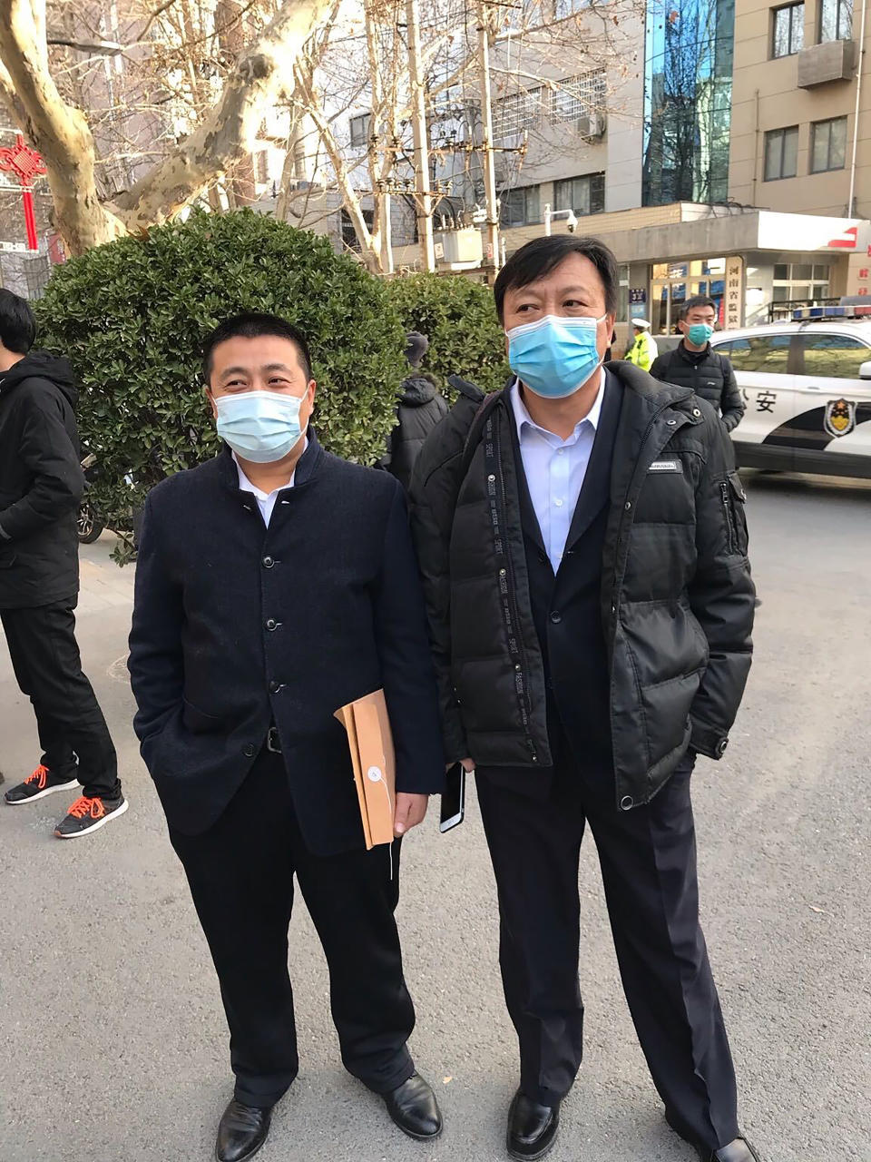 In this photo provided to the Associated Press, Chinese lawyer Ren Quanniu, left, stands with his attorney Bao Longjun outside the Henan provincial Justice Department's office in Zhengzhou in central China's Henan Province, Friday, Jan. 29, 2021. A second Chinese lawyer who represented a Hong Kong pro-democracy activist has been stripped of his license as Beijing attempts to crush opposition to its tighter control over the territory. (AP Photo)