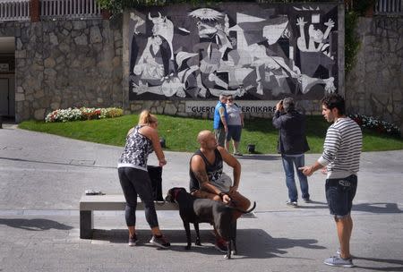 Tourists take pictures in front of a ceramic reproduction of Picasso's Guernica in the Basque town of Guernica, northern Spain, September 21, 2016. REUTERS/Vincent West