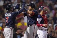 Atlanta Braves' Austin Riley, center, is congratulated by Dansby Swanson (7) after his two run home run off Boston Red Sox starting pitcher Rich Hill during the third inning of a baseball game, Tuesday, Aug. 9, 2022, in Boston. At right is Boston Red Sox catcher Kevin Plawecki. (AP Photo/Charles Krupa)