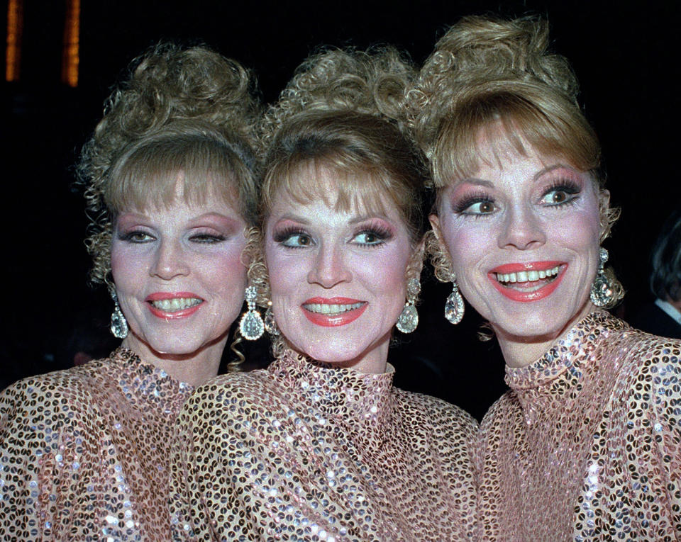 FILE - In this Thursday, Oct. 10, 1986 file photo, The McGuire Sisters, from left, Christine, Phyllis and Dorothy, pose outside Radio City Music Hall in New York. Phyllis McGuire, the last surviving member of the three singing McGuire Sisters who topped the charts with several hits in the 1950s, has died, Tuesday, Dec. 31, 2020. She was 89. (AP Photo/Ed Bailey, File)