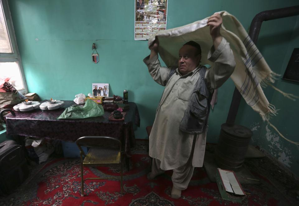 Zabulon Simintov, an Afghan Jew, prepares for prayers at his residence in Kabul