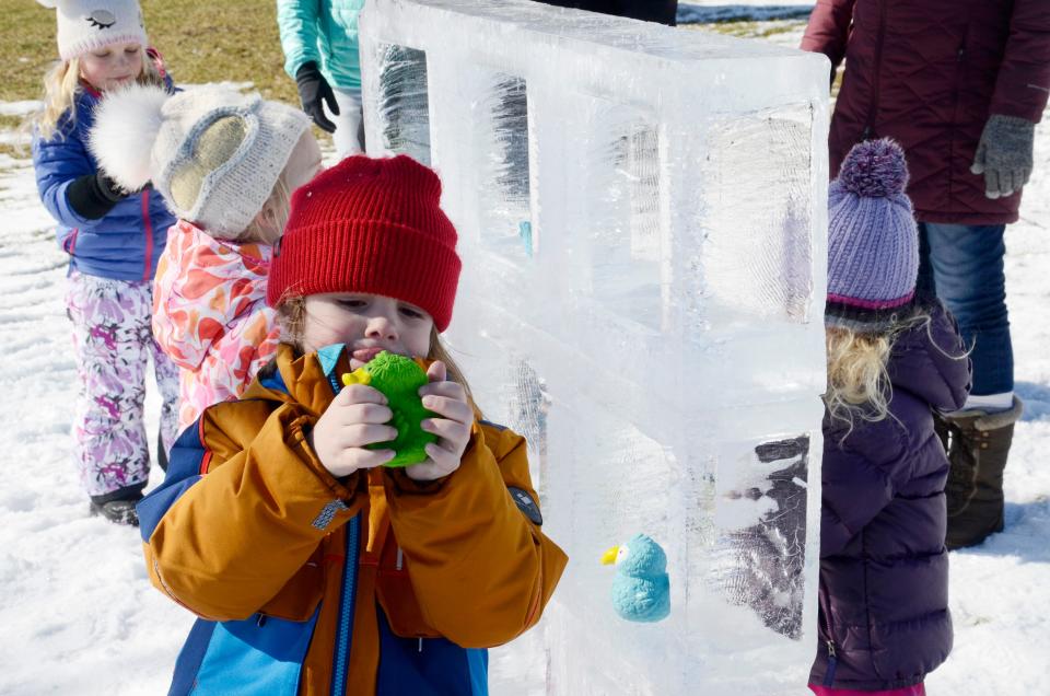 Otto Vandenbrink, 5, from Harbor Springs plays tic tac toe with squeaky toys and an ice playing board on Saturday, Feb. 11, 2023 during the Harbor Springs Ice Fest.