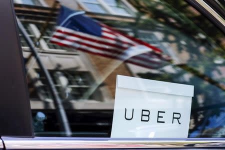 FILE PHOTO: An Uber sign is seen in a car in New York, U.S. June 30, 2015. REUTERS/Eduardo Munoz/File Photo