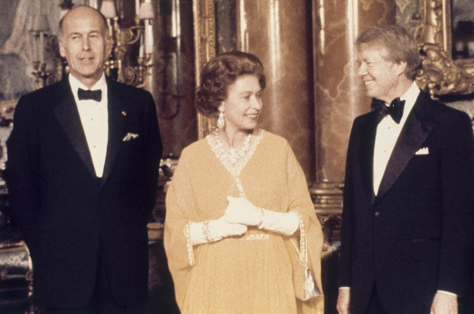 FILE - In this photo dated May 1977, U.S. President Jimmy Carter, right, and Queen Elizabeth II stand with French President Valery Giscard d'Estaing, at Buckingham Palace in London. Queen Elizabeth II, Britain's longest-reigning monarch and a rock of stability across much of a turbulent century, died Thursday, Sept. 8, 2022, after 70 years on the throne. She was 96. (AP Photo, File)