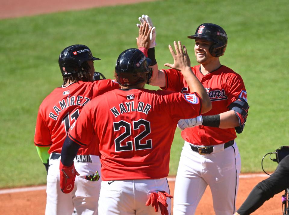 Guardians outfielder Lane Thomas (8) celebrates with Josh Naylor (22) and Jose Ramirez (11) after hitting a three-run home run against the Tigers in the first inning in Game 1 of the ALDS, Oct. 5, 2024, in Cleveland.