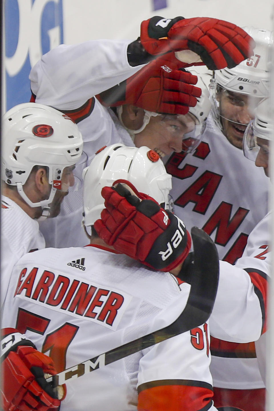 Carolina Hurricanes' Morgan Geekie, center, celebrates with teammates after scoring his first goal in the NHL during the first period of an NHL hockey game against the Pittsburgh Penguins, Sunday, March 8, 2020, in Pittsburgh. (AP Photo/Keith Srakocic)