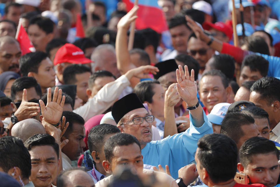Malaysia reform icon Anwar Ibrahim, waves to his supporters as he arrives for by-election nomination in Port Dickson, Malaysia, Saturday, Sept. 29, 2018. Anwar is contesting by-election in Port Dickson, a southern coastal town after a lawmaker vacated the seat to make way for Anwar Ibrahim's political comeback. (AP Photo/Vincent Thian)