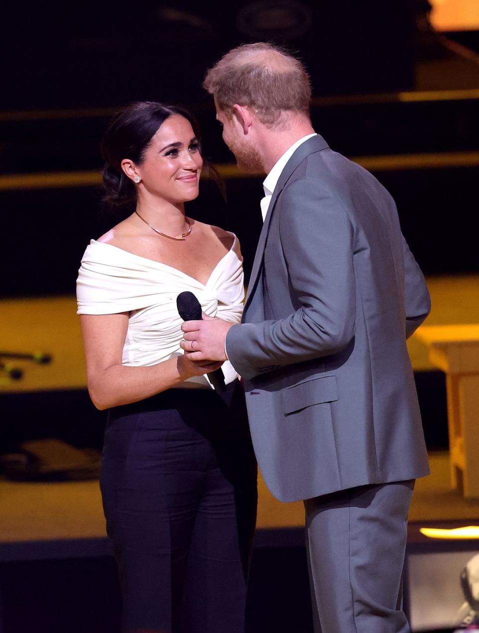 <p>Prince Harry and Meghan Markle traveled to the Hague, in the Netherlands, for the previously postponed Invictus Games. This trip marked their first public international trip together since <a href="https://www.townandcountrymag.com/society/tradition/a31946869/meghan-markle-prince-harry-archie-move-la-us/" rel="nofollow noopener" target="_blank" data-ylk="slk:moving to California in March 2020;elm:context_link;itc:0;sec:content-canvas" class="link ">moving to California in March 2020</a>. On their way to the Games, <a href="https://www.townandcountrymag.com/society/tradition/a39728772/prince-harry-meghan-markle-visited-queen-elizabeth-april-2022/" rel="nofollow noopener" target="_blank" data-ylk="slk:Meghan and Harry stopped in Windsor to visit Queen Elizabeth;elm:context_link;itc:0;sec:content-canvas" class="link ">Meghan and Harry stopped in Windsor to visit Queen Elizabeth</a>.</p><p>During the opening ceremony, Meghan took to the stage to introduce Harry, calling him her "incredible husband" and "the father to our little ones, Archie and Lili." The two shared a very sweet moment on stage (pictured), and <a href="https://www.townandcountrymag.com/society/tradition/a39744050/prince-harry-meghan-markle-invictus-games-opening-ceremony/" rel="nofollow noopener" target="_blank" data-ylk="slk:they kissed;elm:context_link;itc:0;sec:content-canvas" class="link ">they kissed</a>.</p><p><a class="link " href="https://www.townandcountrymag.com/society/tradition/g39735987/meghan-markle-prince-harry-invictus-games-2022-photos/" rel="nofollow noopener" target="_blank" data-ylk="slk:All the Best Photos of Meghan & Harry at the Invictus Games;elm:context_link;itc:0;sec:content-canvas">All the Best Photos of Meghan & Harry at the Invictus Games</a></p>