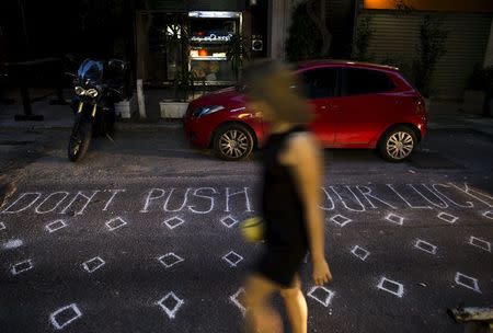 A woman walks along a street in Athens, Greece June 27, 2015. REUTERS/Marko Djurica