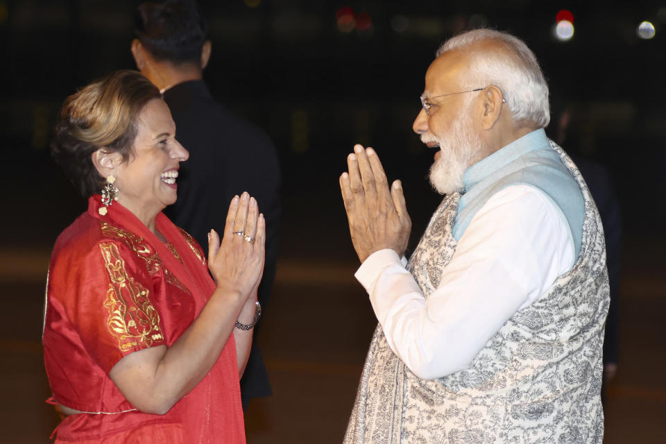 ADDS NAME OF AUSTRALIAN POLITICIAN AT LEFT - India's Prime Minister Narendra Modi, right, is met by Australian politician Michelle Rowland, left, as he arrives at the Sydney international airport on Monday, May 22, 2023, to begin his three-day visit to Australia. (Dave Gray/Pool Photo via AP)