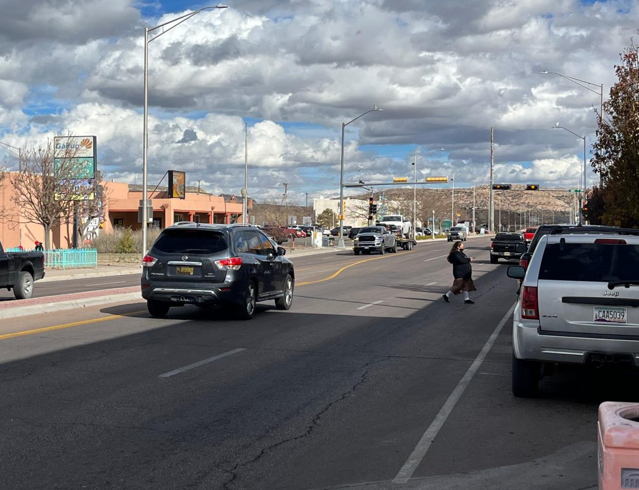 A woman crosses historic Route 66 in downtown Gallup, N.M.