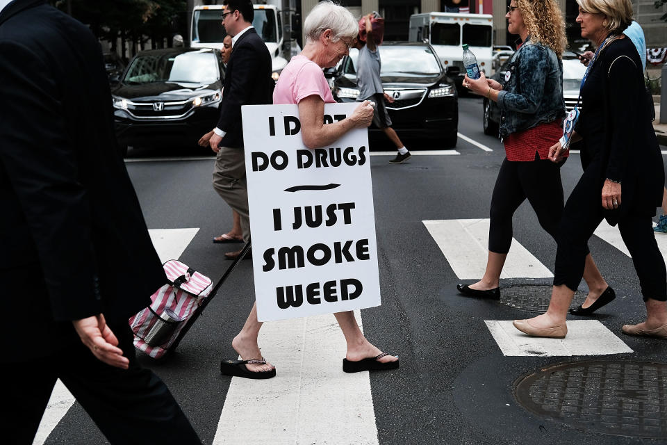 PHILADELPHIA, PA - JULY 28: A woman walks with a sign supporting legalizing marijuana during the Democratic National Convention (DNC) on July 28, 2016 in Philadelphia, Pennsylvania. The convention officially began on Monday and has attracted thousands of protesters, members of the media and Democratic delegates to the City of Brotherly Love.  (Photo by Spencer Platt/Getty Images)