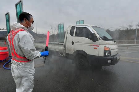 A South Korean health official disinfects a vehicle to prevent spread of bird flu in Pohang, South Korea, December 19, 2016. Choi Chang-ho/News1 via REUTERS