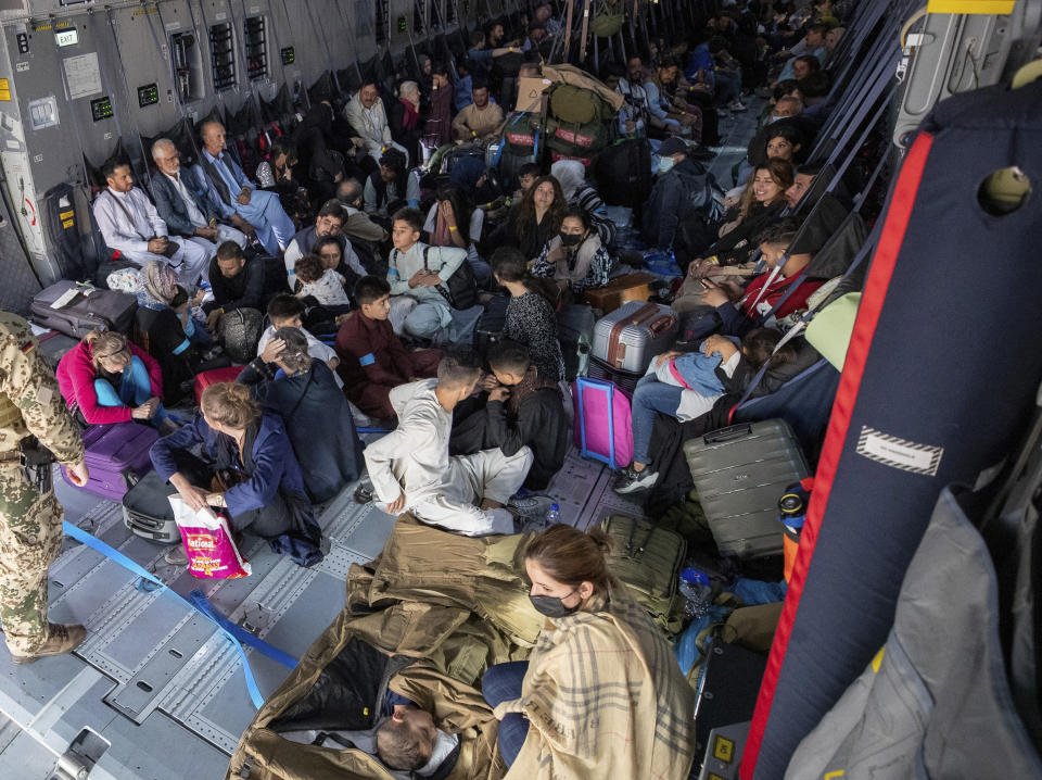 People sit in a German Bundeswehr airplane at the airport in Kabul, Afghanistan, Tuesday, Aug. 17, 2021, as the federal armed forces evacuates German citizens and local Afghans who worked for Germany. (Bundeswehr via AP)