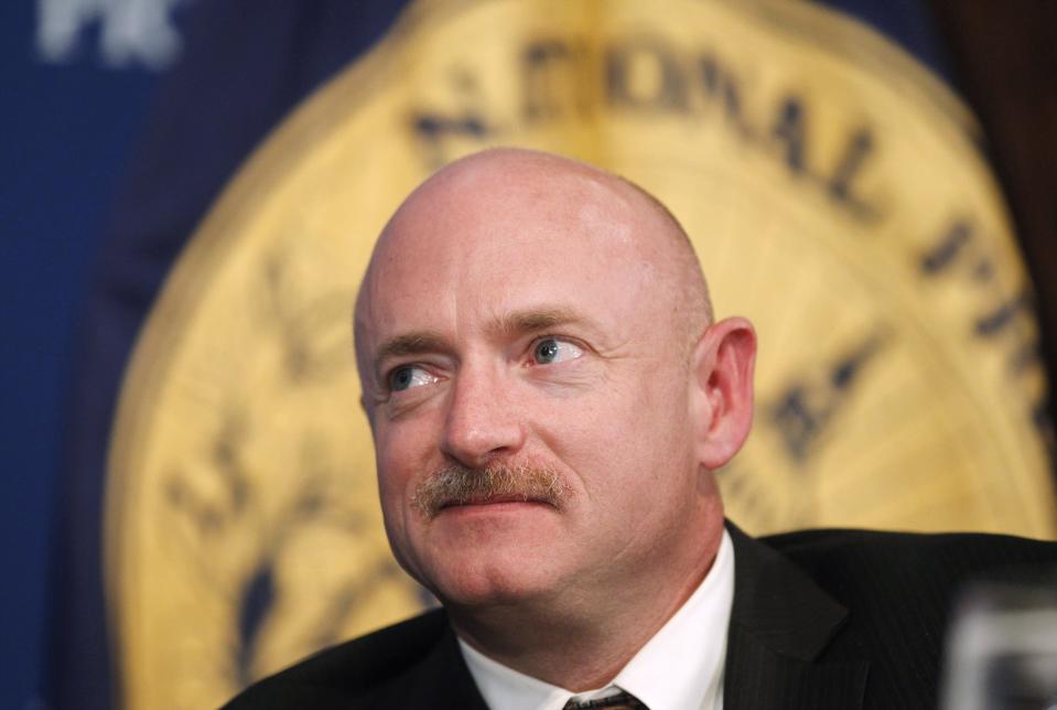 FILE - In this Friday, July 1, 2011, file photo, NASA Space Shuttle astronaut Capt. Mark Kelly, husband of wounded Rep. Gabrielle Giffords, D-Ariz., listens during a luncheon at the National Press Club in Washington. If Arizona Democrat Mark Kelly wins a seat in the U.S. Senate, he could take office as early as Nov. 30, 2020. A Kelly victory would shrink the GOP's Senate majority at a crucial moment and complicate the path to confirmation for President Donald Trump's Supreme Court nominee. (AP Photo/Charles Dharapak, File)