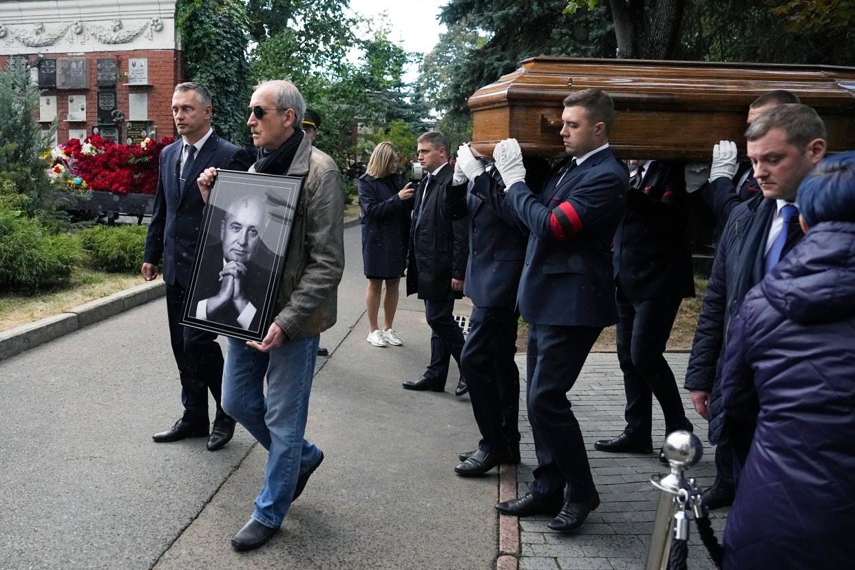 Memorial service personnel carry the coffin of former Soviet President Mikhail Gorbachev during his funeral at Novodevichy Cemetery in Moscow, Russia, Saturday, Sept. 3, 2022. 