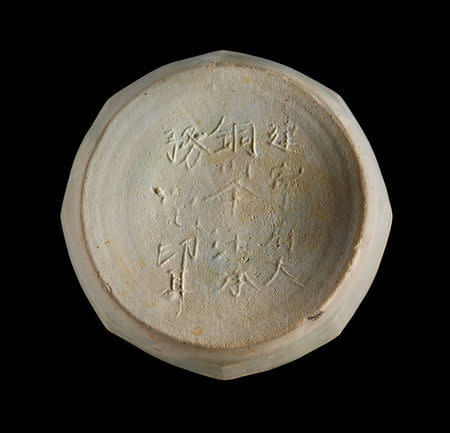 Ceramic box base with a Chinese inscription that mentions a place, Jianning Fu, which dates from AD 1162 to 1278, from the Java Sea Shipwreck, which was discovered in the 1980s west of Indonesia's island of Sumatra, is shown in an image released by the Field Museum in Chicago, Illinois, U.S., May 17, 2018. Courtesy Gedi Jakovickas/The Field Museum/Handout via REUTERS