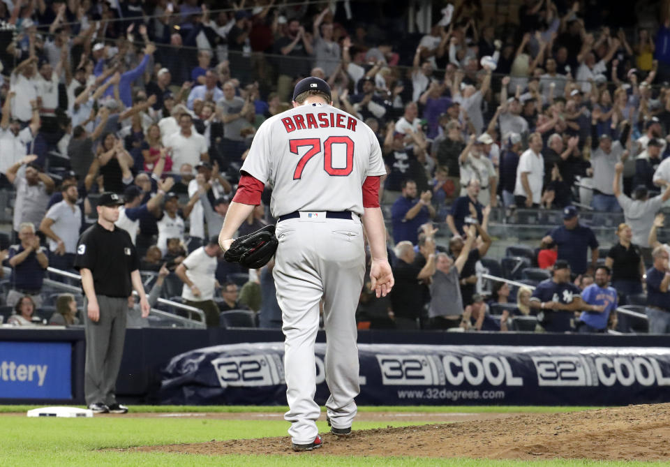 Boston Red Sox relief pitcher Ryan Brasier reacts after giving up a three-run home run to New York Yankees' Neil Walker during the seventh inning of a baseball game Tuesday, Sept. 18, 2018, in New York. (AP Photo/Julio Cortez)