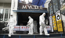 Workers spray disinfectant in front of the MADE, a major club in the international tourist district of Itaewon, in Seoul, South Korea, on May 12, 2020. As South Korea significantly relaxes its rigid social distancing rules as a result of waning coronavirus cases, the world is paying close attention to whether it can return to something that resembles normal - or face a virus resurgence. Already, a mini-outbreak linked to nightclubs in Seoul has tested South Korea’s widely praised method for dealing with the disease _ essentially a combination of rapid tracing, testing and treatment, along with stringent social distancing practices. (Lim Hun-jung/Yonhap via AP)