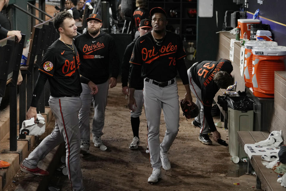 Baltimore Orioles relief pitcher Yennier Cano (78) walks in the dugout after the Texas Rangers defeated the Orioles in Game 3 of a baseball AL Division Series on Tuesday, Oct. 10, 2023, in Arlington, Texas. (AP Photo/Tony Gutierrez)