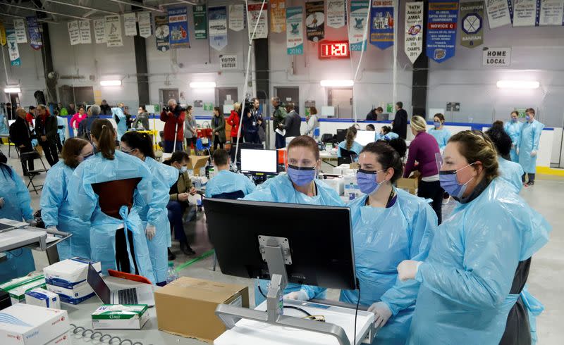 FILE PHOTO: Medical staff prepare to receive patients for coronavirus screening at a temporary assessment center at the Brewer hockey arena in Ottawa