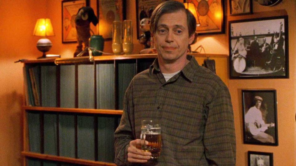 Steve Buscemi holding a beer