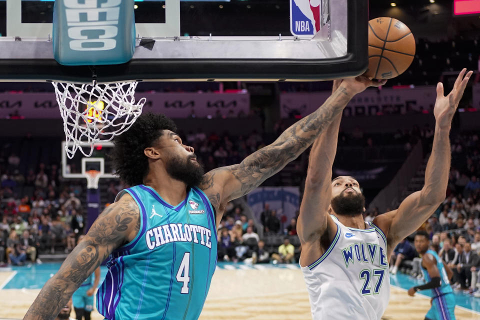 Charlotte Hornets center Nick Richards vies for the ball with Minnesota Timberwolves center Rudy Gobert during the first half of an NBA basketball game Saturday, Dec. 2, 2023, in Charlotte, N.C. (AP Photo/Chris Carlson)