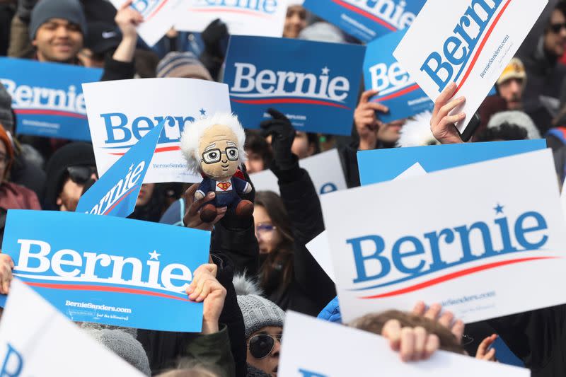 A supporter of Democratic 2020 U.S. presidential candidate Senator Sanders holds a doll depicting him in Boston