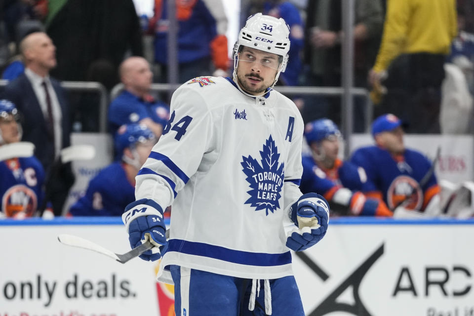 Toronto Maple Leafs' Auston Matthews (34) gestures toward goaltender Martin Jones after scoring a goal during the second period of the team's NHL hockey game against the New York Islanders on Thursday, Jan. 11, 2024, in Elmont, N.Y. (AP Photo/Frank Franklin II)