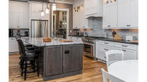 <p>While many kitchens have to choose between storage space and counter space, this smart kitchen design manages to offer an ample amount of both. Bonus: there's even a built-in wine rack. </p>