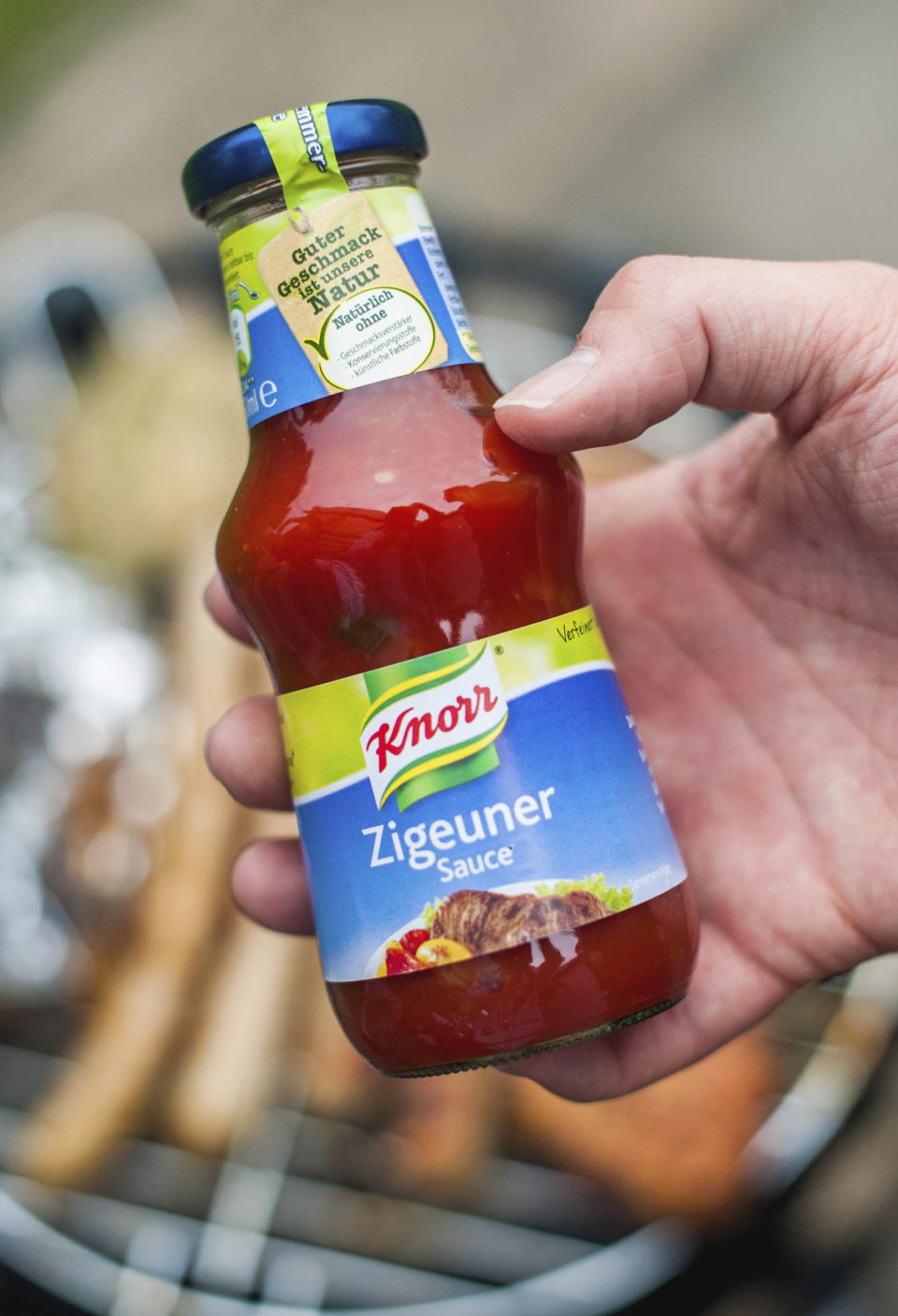 FILE- In this May 6, 2014 taken photo a man holds a bottle of &quot;gypsy sauce&quot; from the manufacturer Knorr in his hand in Berlin, Germany. One of Germany&#39;s best-known food brands has renamed a popular spicy dressing because of the racist connotations of the name. Knorr will change the name of its “Zigeuersauce,” or &quot;gypsy sauce&quot; to Paprika Sauce Hungarian Style,&quot; German weekly Bild am Sonntag reported on Sunday. (Hauke-Christian Dittrich/dpa via AP)