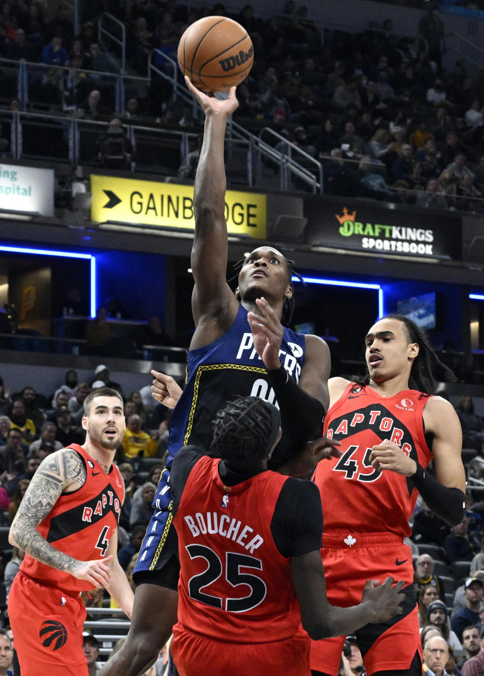 Indiana Pacers guard Bennedict Mathurin (00) shoots over Toronto Raptors forward Chris Boucher (25) during the second half of an NBA basketball game, Saturday, Nov. 12, 2022, in Indianapolis, Ind. (AP Photo/Marc Lebryk)