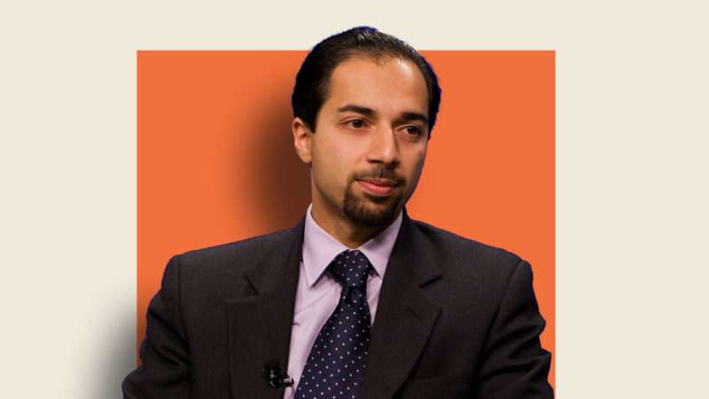 Trita Parsi in front of orange square background