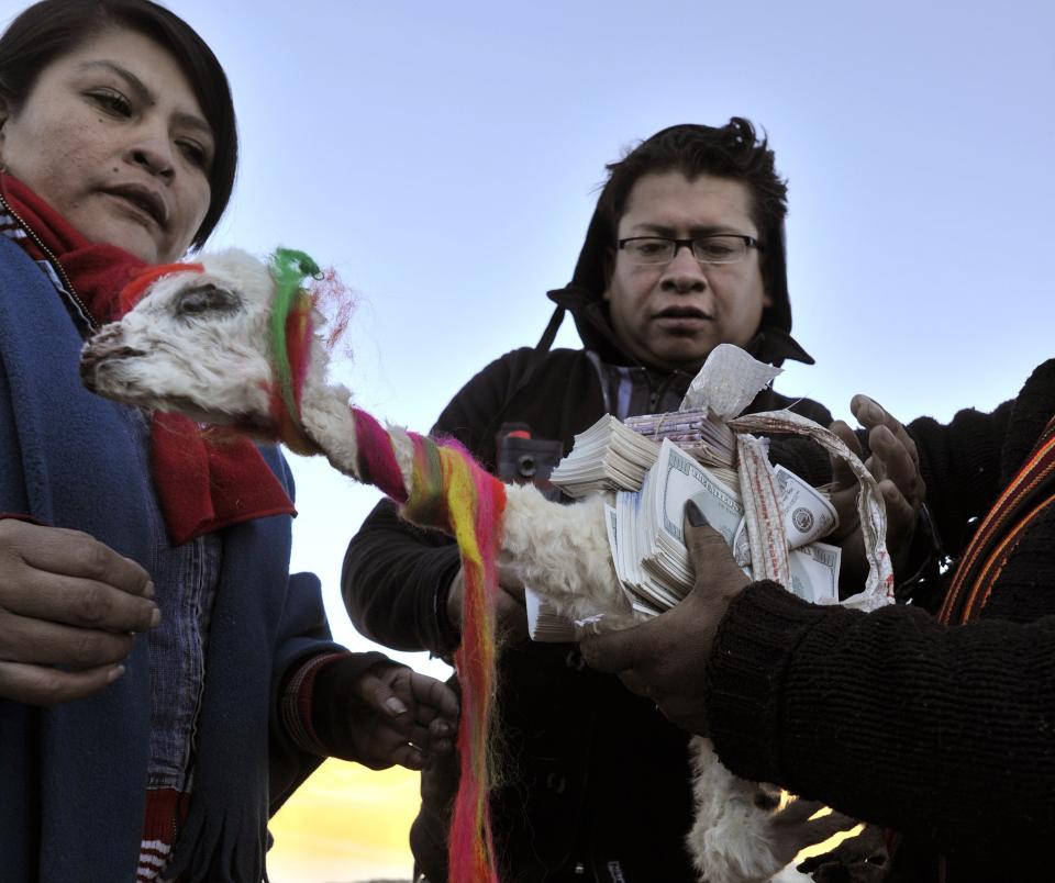 A 'yatiri' (Aymara priest) prepares the elements for a ritual altar to perform a ceremony to thank the Pachamama (Mother Earth) on August 1, 2013 at La Cumbre, 25 km from La Paz. August is a month dedicated to celebrate the Andean godess. AFP/PHOTO/AIZAR RALDES         (Photo credit should read AIZAR RALDES/AFP/Getty Images)