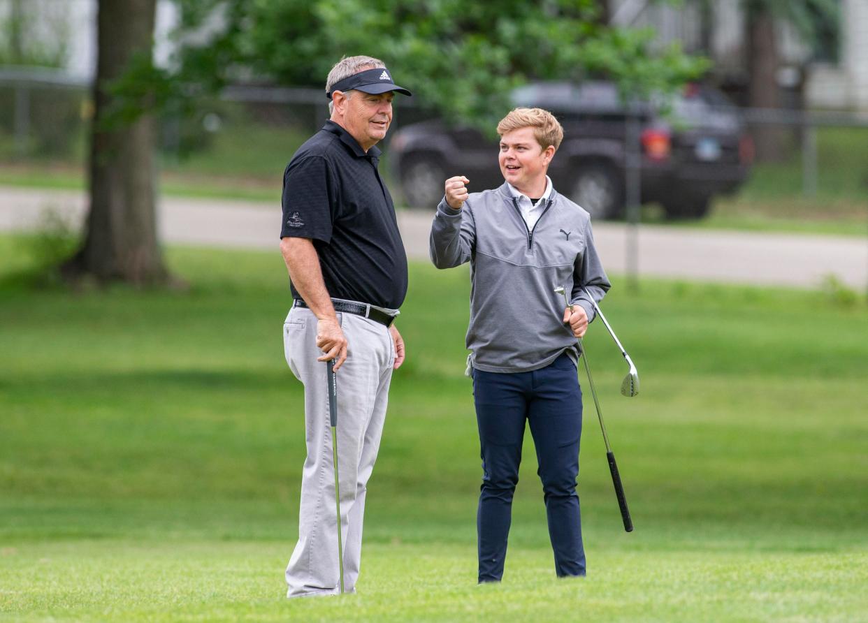 Brian Silvers, left, and his son, Jon, talk on Saturday, June 11, 2022, at Ingersoll Golf Course in Rockford, during the Ballard Memorial tournament, which was changed to a best ball format this year.