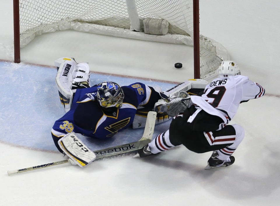 Chicago Blackhawks' Jonathan Toews, right, scores the game-winning goal past St. Louis Blues goalie Ryan Miller during overtime in Game 5 of a first-round NHL hockey playoff series Friday, April 25, 2014, in St. Louis. The Blackhawks one 3-2. (AP Photo/Jeff Roberson)