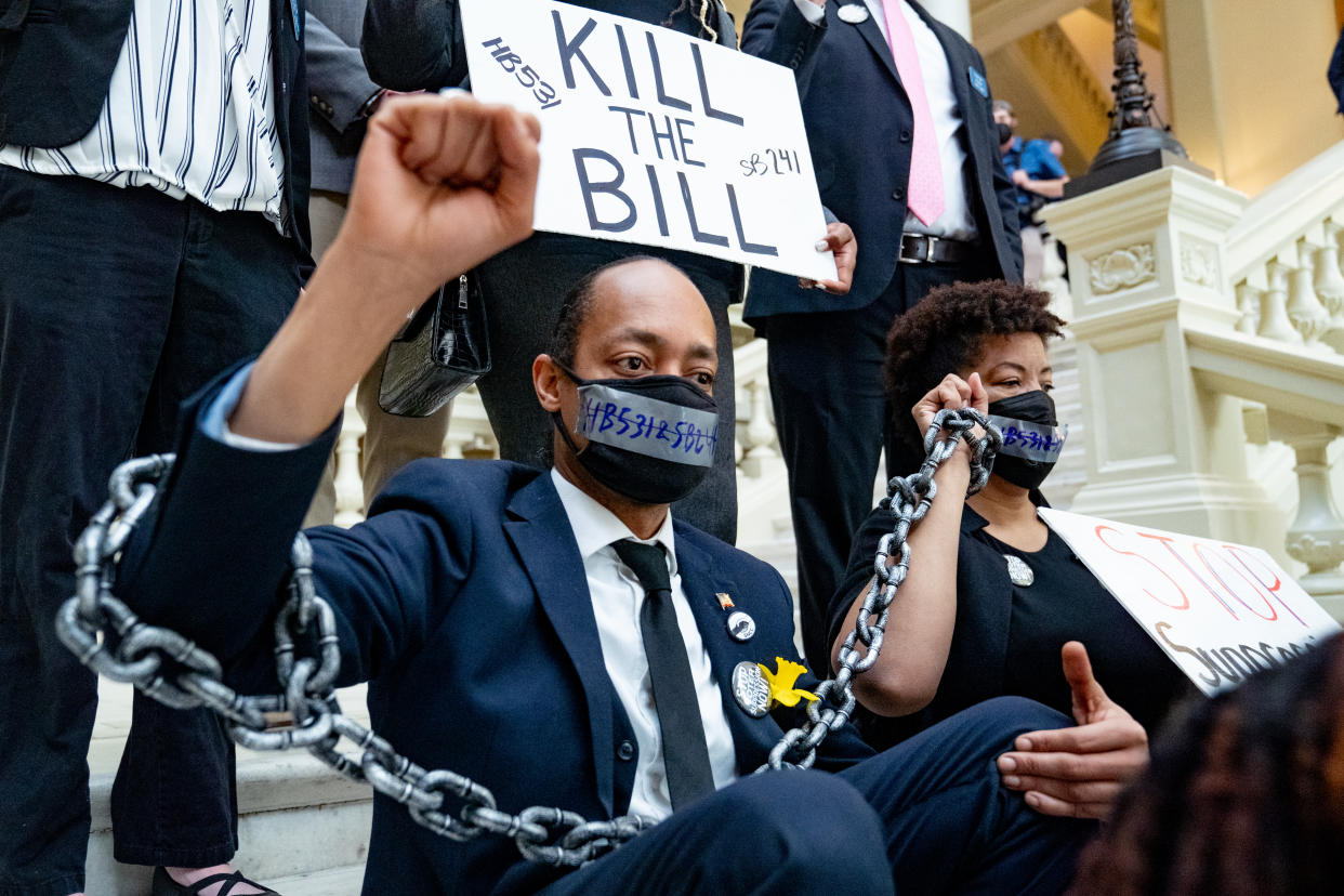 Demonstrators wear chains while holding a sit-in inside of the Capitol building in opposition of House Bill 531 on March 8, 2021 in Atlanta, Georgia. (Megan Varner/Getty Images)