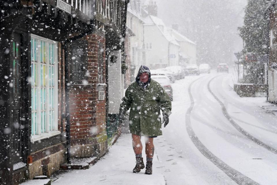 File photo: A man walks through snow (PA Wire)